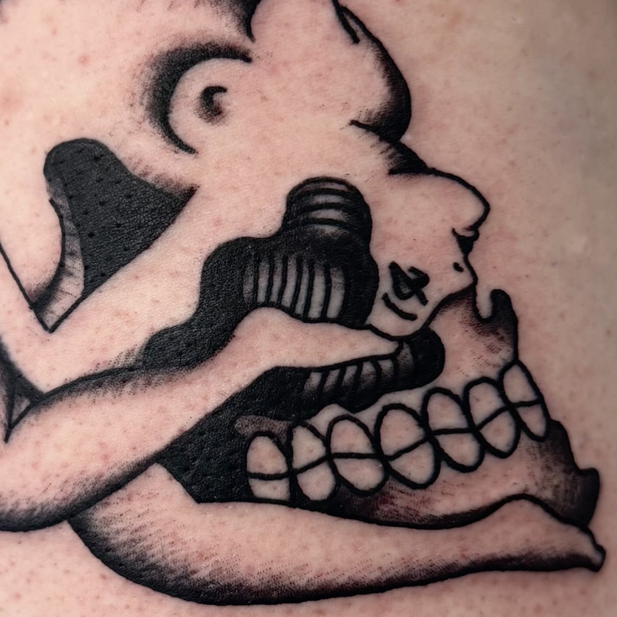 Bold blackwork skull and jaw tattoo in heavy solid black